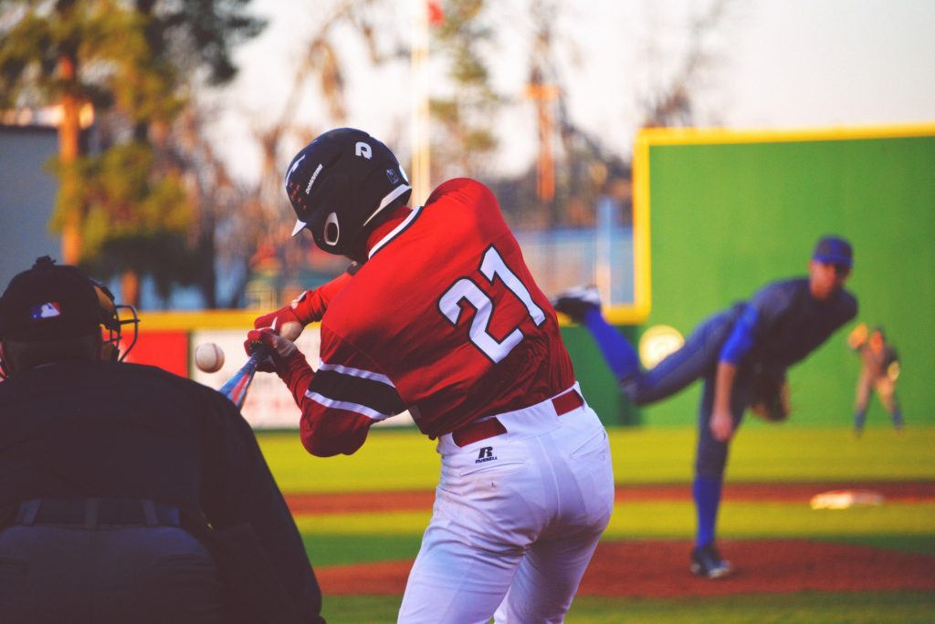 A baseball player swinging at the ball during a game.